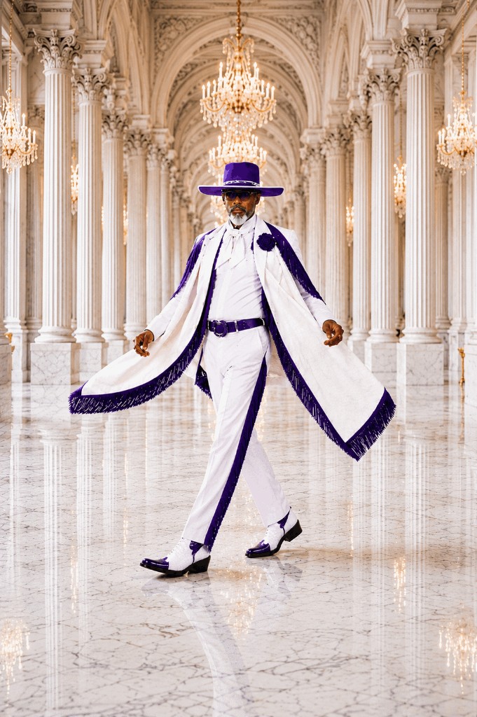 View white and purple look Western GQ luxury fashion — white fringe cape and purple hat, marble column hall with chandeliers; opens full gallery
